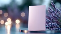 Blank white greeting card mockup with lavender flowers against blurred bokeh lights background, creating romantic mood for special occasions.
