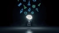 Glowing light bulb with brain filament emitting science and technology icons on dark background representing innovation and creative thinking.