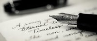 Fountain pen writing cursive text on paper with blurred documents in background, suitable for education, writing, correspondence, and business communication projects.