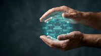 Hands of middle-aged male professional cradling glowing digital globe with interconnected network nodes and business terms, representing global connectivity, innovation, and future technology solutions.