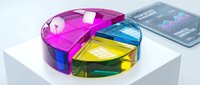 Colorful transparent glass pie chart with vibrant segments in pink, blue, yellow and green displaying business data analytics and financial statistics.