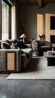 Cozy modern living room with a fluffy cat resting on a gray sofa, warm lighting, stone coffee table, and elegant neutral tones.
