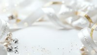 Elegant white and gold holiday decorations with ribbons and ornaments creating festive celebration background for seasonal greeting cards and party invitations.