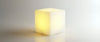 Glowing cube lamp emitting soft yellow light, isolated on white background for design, advertising, and product visualization purposes.