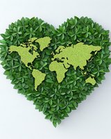 Green heart-shaped arrangement of leaves with world map silhouette in lime color on white background, representing eco-friendly and environmental conservation concept.