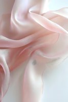 Soft flowing pink silk fabric with gentle folds and curves creating an ethereal abstract composition, suitable for luxury fashion and wedding backgrounds.