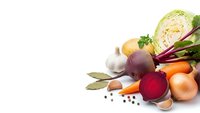 Fresh organic vegetables including beetroot, cabbage, carrots, onions and herbs arranged on white background for healthy cooking and nutrition concepts.
