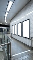Modern subway station platform with blank white advertising billboards on tiled wall, fluorescent ceiling lights, metal railings, and train visible in background for transit advertising campaigns.