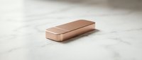 Rose gold metallic rectangular bar on white marble surface for luxury branding, jewelry design, and premium product presentations.