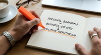 Professional highlighting personal branding business growth and positive reputation concepts on notebook with orange marker at modern workspace.