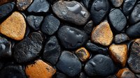 Wet black and orange stones background with water drops, natural texture pattern for spa and wellness design, close up of smooth pebbles surface.