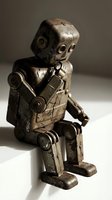 Vintage tin toy robot with weathered metallic finish, articulated limbs, and mechanical details. Antique wind-up automaton collectible for retro decor and nostalgic themes.