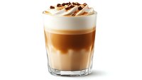 Layered coffee drink with caramel, milk, and whipped cream topped with chocolate pieces in clear glass, perfect for cafe menu promotion.