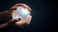 Hands protecting glowing sphere with magical light effects on dark background for fortune telling and mystical energy concepts.