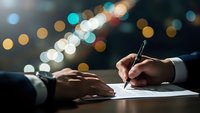 Professional businessman signing important contract document at night with elegant bokeh city lights creating atmospheric business environment.