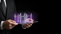 Businessman holding tablet with holographic people projections representing digital workforce, virtual team management, and futuristic business technology solutions.
