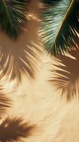 Palm leaves casting natural shadows on beige textured wall in sunlight, creating tropical minimalist pattern with green fronds and warm tones.