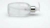 Clear glass perfume bottle with silver spray pump isolated on white background for cosmetic and fragrance product design.