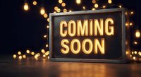 Illuminated coming soon sign with warm golden lights creating anticipation for new business opening or product launch announcement.
