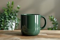 Dark green ceramic coffee mug on wooden table with houseplants in background for kitchen and home decor concepts.