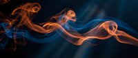 Abstract orange and blue smoke waves flowing gracefully against dark background creating dynamic ethereal patterns for modern design projects.