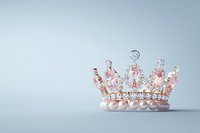Delicate pink crystal and pearl crown with ornate silver details on soft blue background, showcasing royal elegance and feminine luxury for wedding and princess themes.