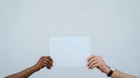 Two hands holding blank white card against neutral background for mockup and branding purposes.