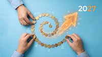 Business growth strategy concept with hands arranging coins in spiral path leading to upward arrow and 2027 year on blue background for financial planning.