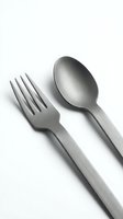 Stainless steel fork and spoon cutlery set isolated on white background for kitchen dining and restaurant use.