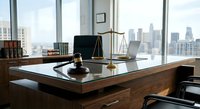 Professional law office interior with wooden desk, gavel, scales of justice and city skyline view through large windows for legal services.