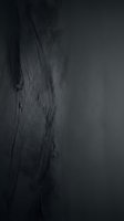 Dark textured surface with organic flowing lines and scratches, creating an abstract moody composition suitable for backgrounds and design projects.