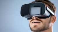 Young Caucasian man wearing virtual reality headset against light background, experiencing immersive VR technology with focused expression and slight smile.
