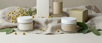 Natural skincare cosmetic products with eucalyptus leaves and chamomile flowers on neutral beige background for spa wellness beauty routine.