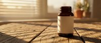 Brown glass medicine bottle with blank label on wooden table in warm sunlight streaming through window blinds creating natural shadows and cozy atmosphere.