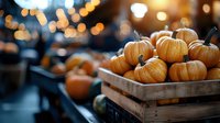 Fresh orange pumpkins in rustic wooden crate with blurred bokeh lights background, autumn harvest mood for seasonal fall decoration and Halloween.