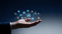 Young male professional hand holding glowing network icons representing digital connectivity, technology infrastructure, and business communication solutions for corporate applications.