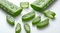 Fresh cucumber slices and halves with water droplets arranged on white background, suitable for healthy food, nutrition, wellness, and culinary design projects.