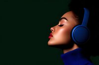 Young African American woman with closed eyes and red lips wearing blue headphones and turtleneck sweater against dark green background in profile view.