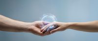 Two hands reaching toward each other with glowing digital energy connection, symbolizing partnership, collaboration and human connection in modern world.
