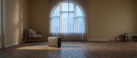 Spacious minimalist interior with arched window, wooden floor, and neutral furnishings creating a serene, light-filled space for modern home design and architectural visualization projects.