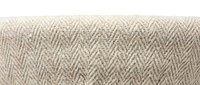 Natural beige herringbone fabric texture with woven zigzag pattern for upholstery and interior design projects on white background.