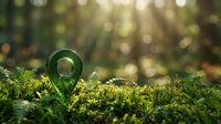 Green location pin marker on moss in forest with sunlight bokeh background for eco-friendly navigation and sustainable travel concepts.