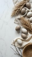 Natural speckled eggs arranged with dried wheat stalks and wicker basket on marble surface for Easter spring decoration and rustic farmhouse styling.