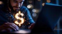 Bearded male entrepreneur holding glowing dollar sign symbol on laptop, representing digital wealth, financial success, online business growth and cryptocurrency investment opportunities.
