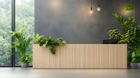 Modern wooden reception desk with green plants in contemporary office space with concrete wall and pendant lights, perfect for business interiors.