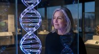 Middle-aged Caucasian female scientist examining holographic DNA double helix structure in modern laboratory for genetic research and biotechnology applications.