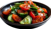 Fresh cucumber and cherry tomato salad with herbs in a dark bowl, dressed with savory sauce. Healthy vegetarian meal concept for food blogs.