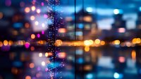 Blurred city lights reflected in glass window with raindrops creating magical bokeh effect in blue and orange tones, urban night atmosphere.