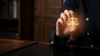 Professional lawyer holding glowing scales of justice symbol in office setting representing legal services and law firm consultation.