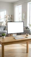 Monitor displaying blank white screen on wooden desk with wireless keyboard, potted plant, and coffee cup in bright modern home office interior with natural light.